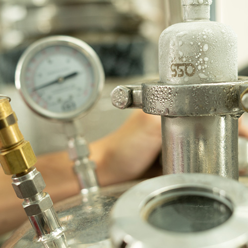 Photo of pressure gauges attached to the top of  air gas tanks.